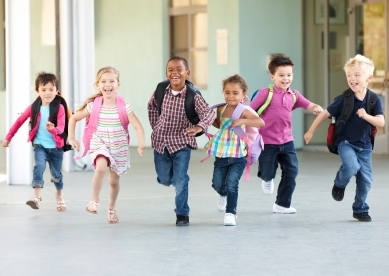 Kids running down school hall together